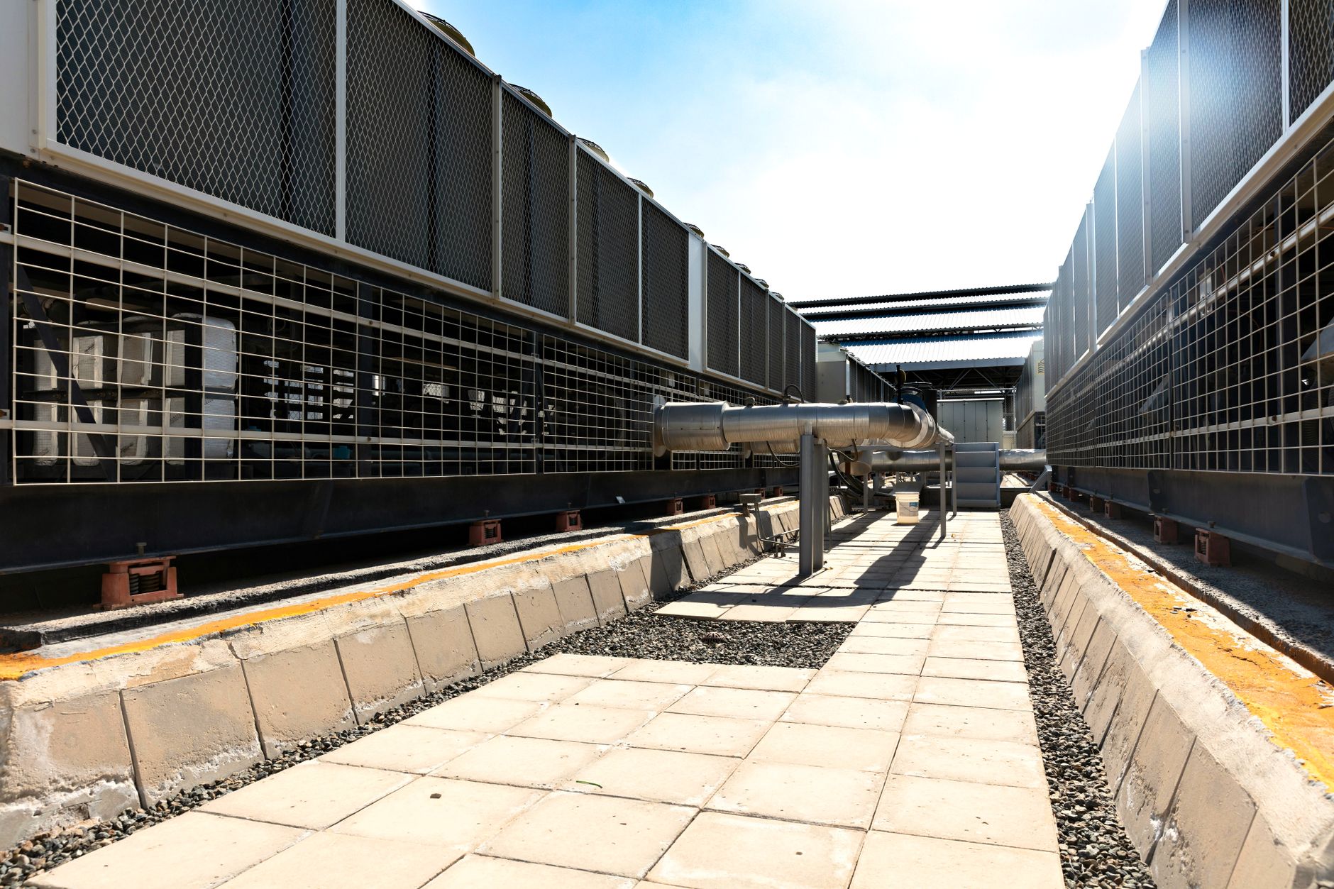 A rooftop plant deck with VRF condensers and an air-cooled chiller on a commercial building